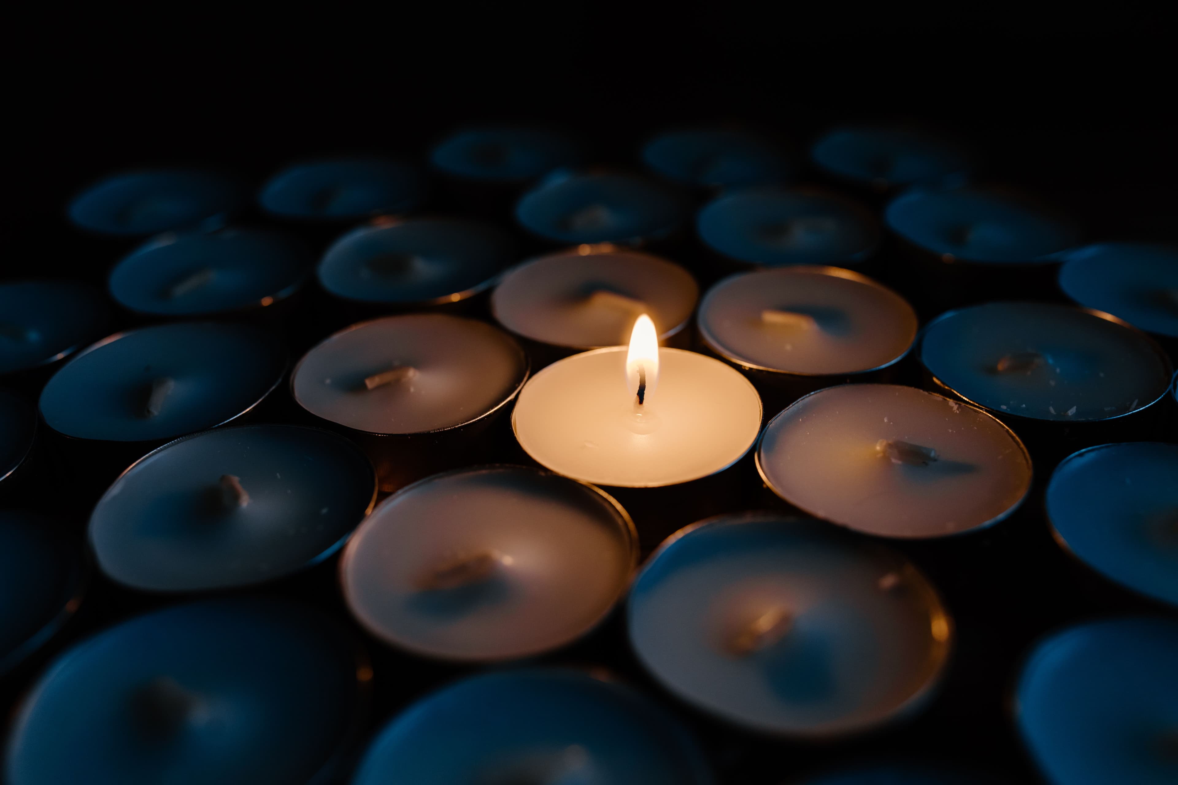 A tealight candle, lit